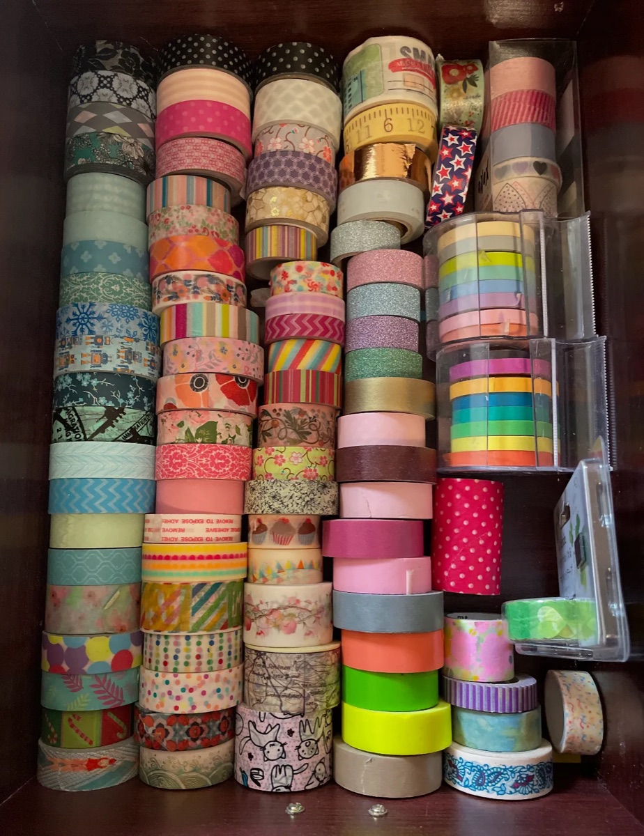 Rolls of washi tape stacked in columns in a drawer